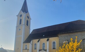 Kirche mit blühendem Strauch